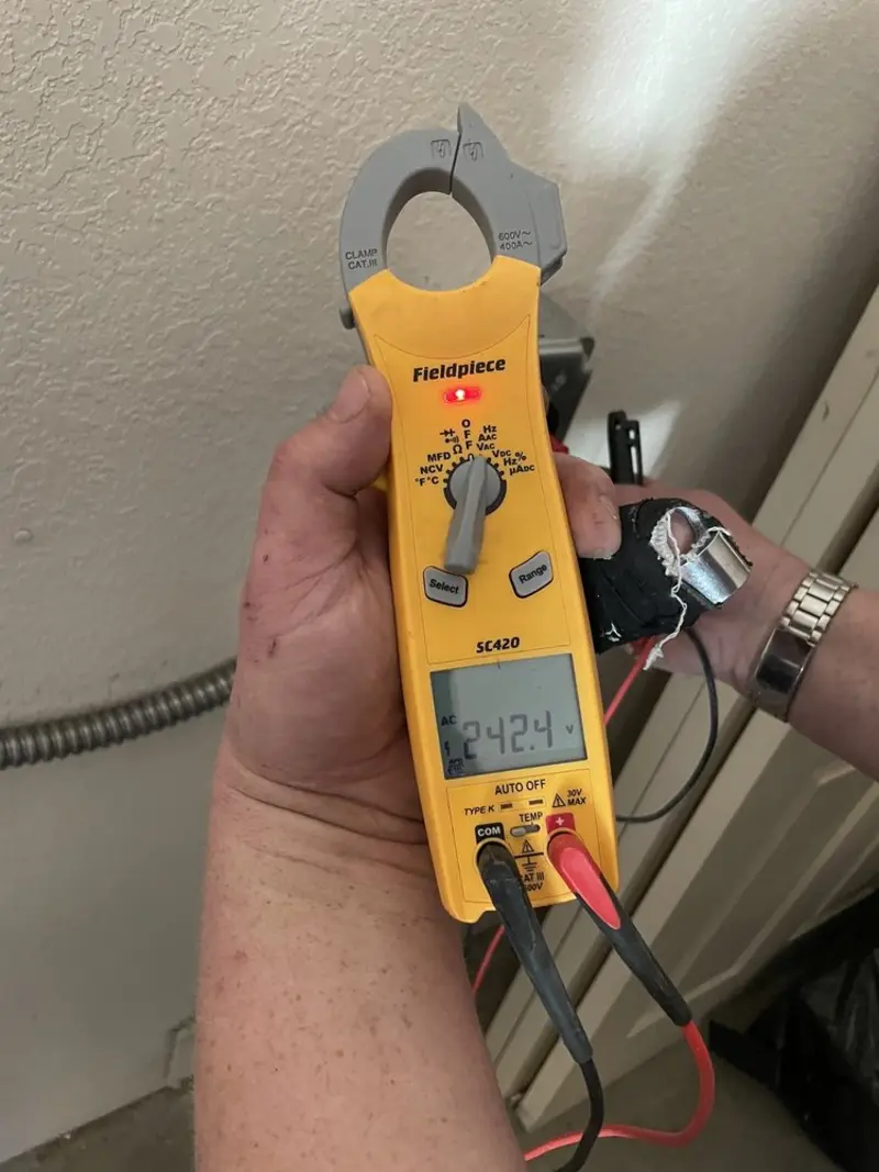 Voltage testing with clamp meter during Whole House Surge Protector in Manor